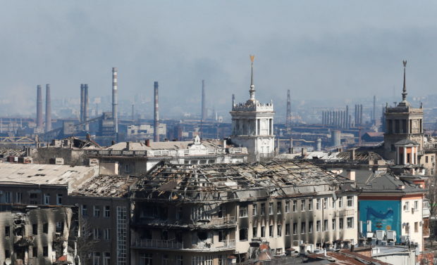FILE PHOTO: A view shows a plant of Azovstal Iron and Steel Works company behind buildings damaged in the course of Ukraine-Russia conflict in the southern port city of Mariupol, Ukraine April 7, 2022. REUTERS/Alexander Ermochenko