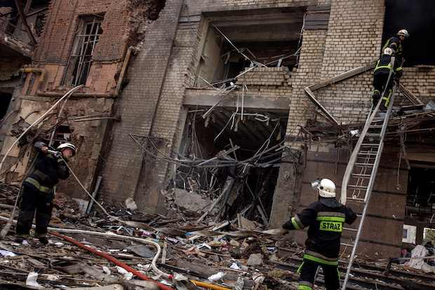 Firefighters operate at a destroyed building in Kharkiv. STORY: Russia hits Kyiv, Lviv; presses offensive in Mariupol