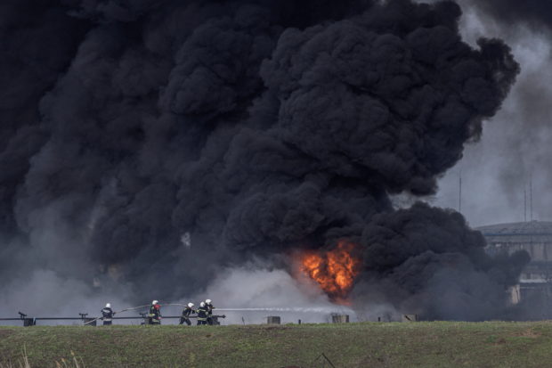 Firefighters work to put out a fire at Lysychansk Oil Refinery after if was hit by a missile at Lysychansk, Luhansk region, Ukraine, April 16, 2022. REUTERS/Marko Djurica