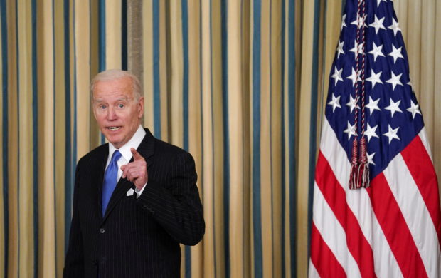 FILE PHOTO: U.S. President Joe Biden answers a question after signing into law H.R. 3076, the "Postal Service Reform Act of 2022" at the White House in Washington, U.S., April 6, 2022. REUTERS/Kevin Lamarque/File Photo