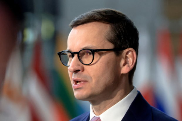 FILE PHOTO: Poland's Prime Minister Mateusz Morawiecki speaks to the media as he arrives for European Union leaders' summit, amid Russia's invasion of Ukraine, in Brussels, Belgium, March 25, 2022. REUTERS/Wolfgang Rattay/File Photo