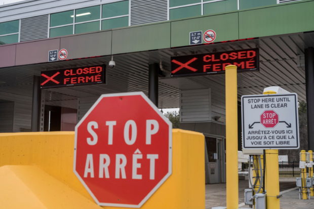 Two closed Canadian border checkpoints are seen after it was announced that the border would close to "non-essential traffic"  to combat the spread of novel coronavirus disease (COVID-19) at the U.S.-Canada border crossing at the Thousand Islands Bridge in Lansdowne, Ontario, Canada March 19, 2020.  REUTERS/Alex Filipe//File Photo