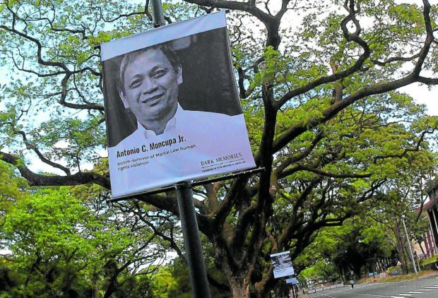 Poster of martial law survivor at the UP Diliman campus. STORY: Presidential bets vow to make rights body stronger