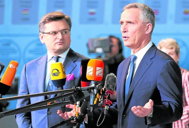 Ukraine's Foreign Minister Dmytro Kuleba (L) and NATO Secretary General Jens Stoltenberg speak to the press as they arrive for a meeting of NATO foreign ministers at NATO headquarters, in Brussels, on April 7, 2022. - Ukraine's Foreign Minister Dmytro Kuleba on April 7, 2022 called on NATO members to provide Kyiv with all the weaponry it needs to fight Russia. "My agenda is very simple. It has only three items on it. Its weapons, weapons, and weapons," Kuleba told journalists ahead of a meeting with NATO foreign ministers in Brussels. (Photo by François WALSCHAERTS / AFP).