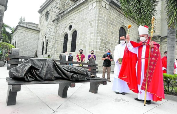 Homeless Jesus in front of the Manila Cathedral. STORY: Sit on the bench with ‘Homeless Jesus’