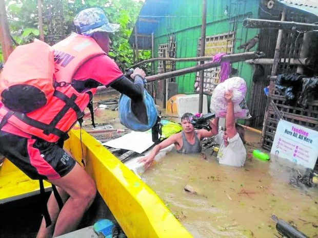Member of PCG rescue team in Capiz. STORY: Almost 140,000 individuals affected by Agaton – NDRRMC
