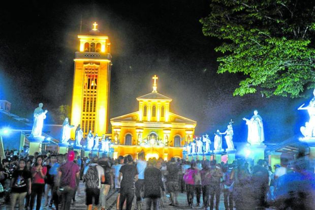  Catholics who joined the Maundy Thursday walk to the Minor Basilica of Our Lady of the Rosary of Manaoag, gather at the church patio