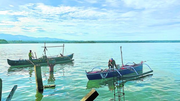 Fishermen in Masinloc town, Zambales province, prepare their boats early in the morning. STORY: From farming to fishing: Central Luzon groups push for reforms