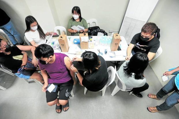VAX GOES ON People continue to get their COVID-19 vaccine shots in Marikina City on Monday as the government begins administering the second booster dose to the most vulnerable members of the population. STORY: Rollout of second booster dose vs COVID-19 starts