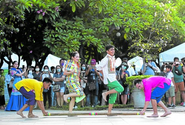 SKIP, STEP, SMILE Unlike their audience, these folk dancers are apparently excused from wearing face masks—or they could not fully project the playfulness of the “tinikling”—for this cultural number during the Manila Coffee Festival held at Fort Santiago in Intramuros, Manila, on Friday. —LYN RILLON