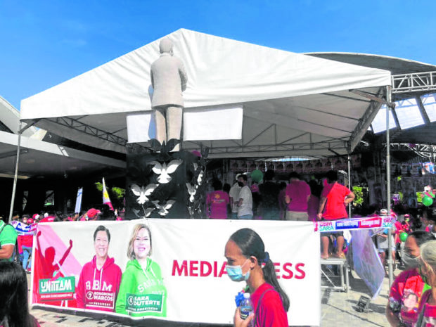 The monument of the late senator Ninoy Aquino at the Tarlac City Plaza has been partly covered by a tent as the Marcos-Duterte tandem holds their rally on Saturday morning. PHOTO BY NESTOR A. CORRALES