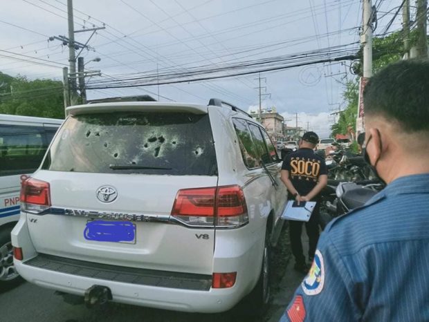 Police inspect the Toyota Land Cruiser after an ambush Thursday in Cotabato City. The lawyer was unharmed. (Photo from Radio DXMS-AM)