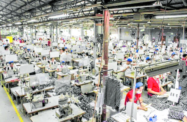 Interior of a garments factory with workers.