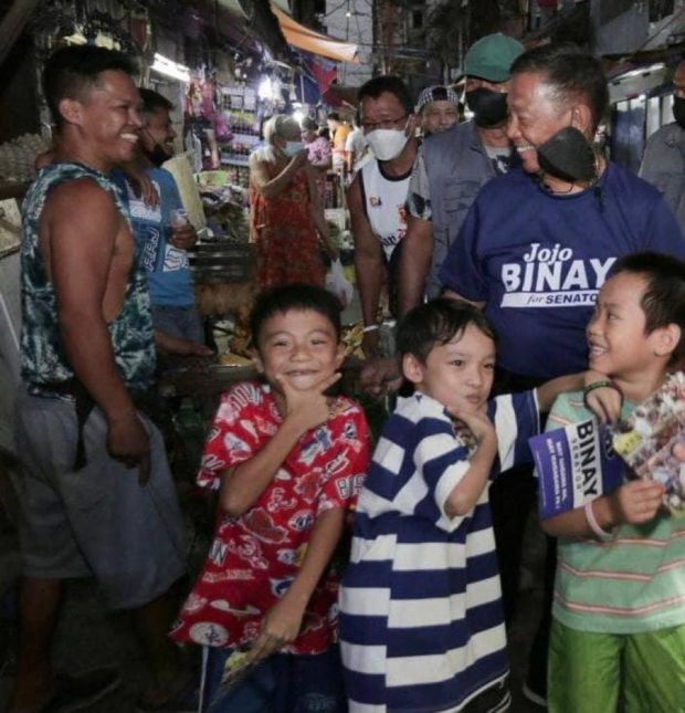 Former Vice President and now senatorial candidate Jejomar Binay is greeted by children singing his campaign jingle “Binay There, Done That!” inside Trabajo Market in Manila