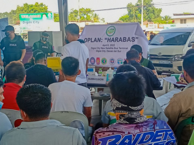 Drivers and conductors of public utility vehicles wait for their turn to be tested during the surprise random drug examination inside the Digos Satellite Terminal in Barangay Aplaya, Digos City on Friday (April 8, 2022). Five were found positive for drug use. (Photo by Jonathan Tudtud, Contributor