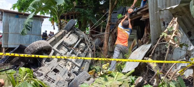 Mlang Engineering Office personnel extricate the Toyota Hi Lux that figured in the car crash along the highway in Mlang town, Cotabato province. Aboard the vehicle, a municipal councilor of Datu Piang in Maguindanao province and his escort died on the spot. WILLIAMOR A. MAGBANUA 