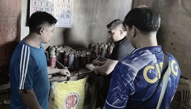 Members of the Criminal Investigation and Detection Group (CIDG) inspect the fake butane canisters seized from the two suspects in Bulacan. (Contributed photo) 