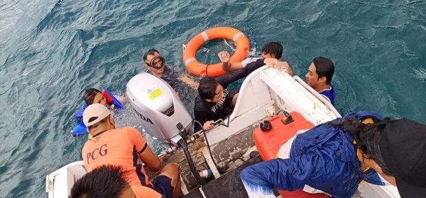 Philippine Coast Guard personnel in Batanes rescue five residents of Basco town after a rowing boat carrying them capsized on April 17 in Chanarian Bay due to strong waves