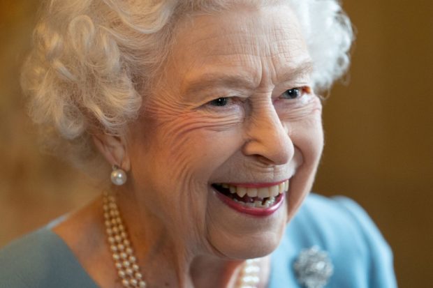 (FILES) In this file photo taken on February 05, 2022 Britain's Queen Elizabeth II smiles during a reception in the Ballroom of Sandringham House, the Queen's Norfolk residence, as she celebrates the start of the Platinum Jubilee. - Elizabeth has reigned for 70 years and nearly four months -- longer than any other monarch in British history. The previous record was held by her great-great-grandmother queen Victoria, who reigned for 63 years, seven months and two days until 1901. At 96, Elizabeth is the oldest current monarch and head of state in the world. (Photo by Joe Giddens / POOL / AFP)