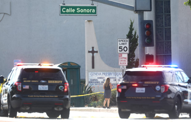 Police vehicles are parked near the scene of a shooting at the Geneva Presbyterian Church on May 15, 2022 in Laguna Woods, California. According to police, the shooting left one person dead, four critically wounded, and one with minor injuries. Mario Tama/Getty Images/AFP (Photo by MARIO TAMA / GETTY IMAGES NORTH AMERICA / Getty Images via AFP)