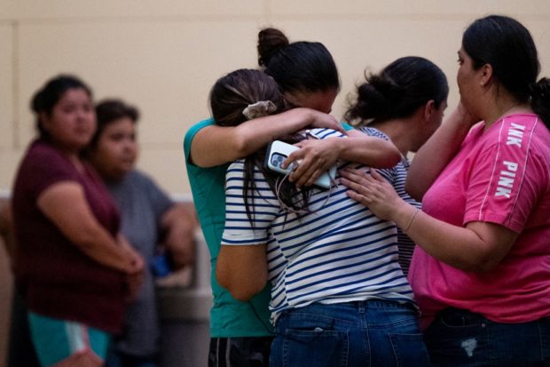 UVALDE, TEXAS - MAY 24: People mourn outside of the SSGT Willie de Leon Civic Center following the mass shooting at Robb Elementary School on May 24, 2022 in Uvalde, Texas. According to reports, 19 students and 2 adults were killed, with the gunman fatally shot by law enforcement.   Brandon Bell/Getty Images/AFP (Photo by Brandon Bell / GETTY IMAGES NORTH AMERICA / Getty Images via AFP)