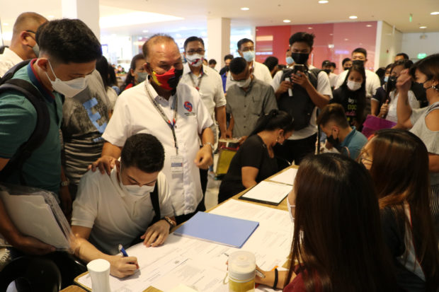 Subic Bay Metropolitan Authority (SBMA) Chair and Administrator Rolen Paulino (standing in center) greets a crowd of job seekers during the first on-site job fair at the Ayala Harbor Point Mall in Subic Bay Freeport