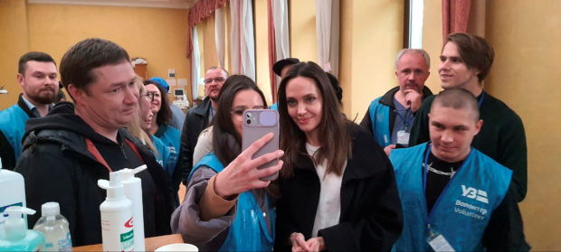 U.S. actor and UNHCR Special Envoy Angelina Jolie gets a selfie taken with a volunteer as she visits Lviv's main railway station, amid Russia's invasion of Ukraine April 30, 2022 in this handout image. Ukrzaliznytsia/Handout via REUTERS