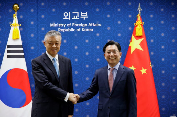 Chinese Special Representative on Korean Peninsula Affairs Liu Xiaoming shakes hands with South Korea's Special Representative for Korean Peninsula Peace and Security Affairs Noh Kyu-duk during a meeting at the Foreign Ministry in Seoul, South Korea, May 3, 2022.  REUTERS/Heo Ran/Pool