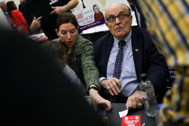 FILE PHOTO - Former New York City mayor and lawyer for former President Donald Trump Rudy Giuliani greets fans as people gather for the "Empowering Michigan 2022" Michigan GOP members convention at DeVos Place in Grand Rapids, Michigan, U.S., April 23, 2022.  REUTERS/Emily Elconin