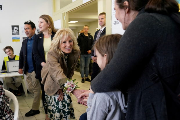 U.S. first lady Jill Biden greets a girl as she meets Ukrainian refugees and humanitarian workers at a city-run refugee center in Kosice, Slovakia, May 8, 2022.   Susan Walsh/Pool via REUTERS