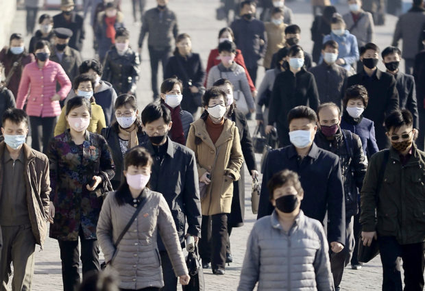 People wearing protective face masks commute amid concerns over the new coronavirus disease (COVID-19) in Pyongyang, North Korea March 30, 2020, in this photo released by Kyodo. Mandatory credit Kyodo/via REUTERS