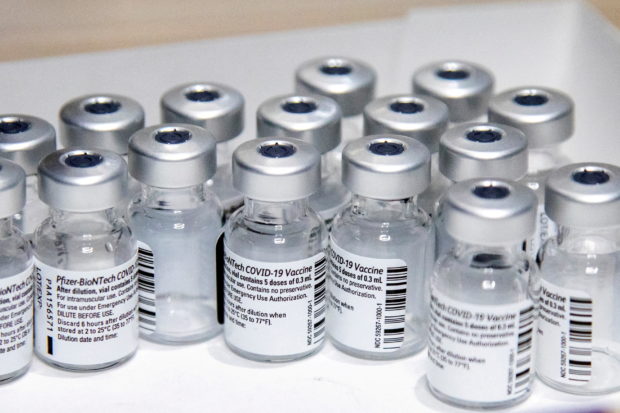 FILE PHOTO: Empty vials of the Pfizer-BioNTech coronavirus disease (COVID-19) vaccine are seen at The Michener Institute, in Toronto, Canada January 4, 2021 in this file photo. REUTERS/Carlos Osorio/File Photo