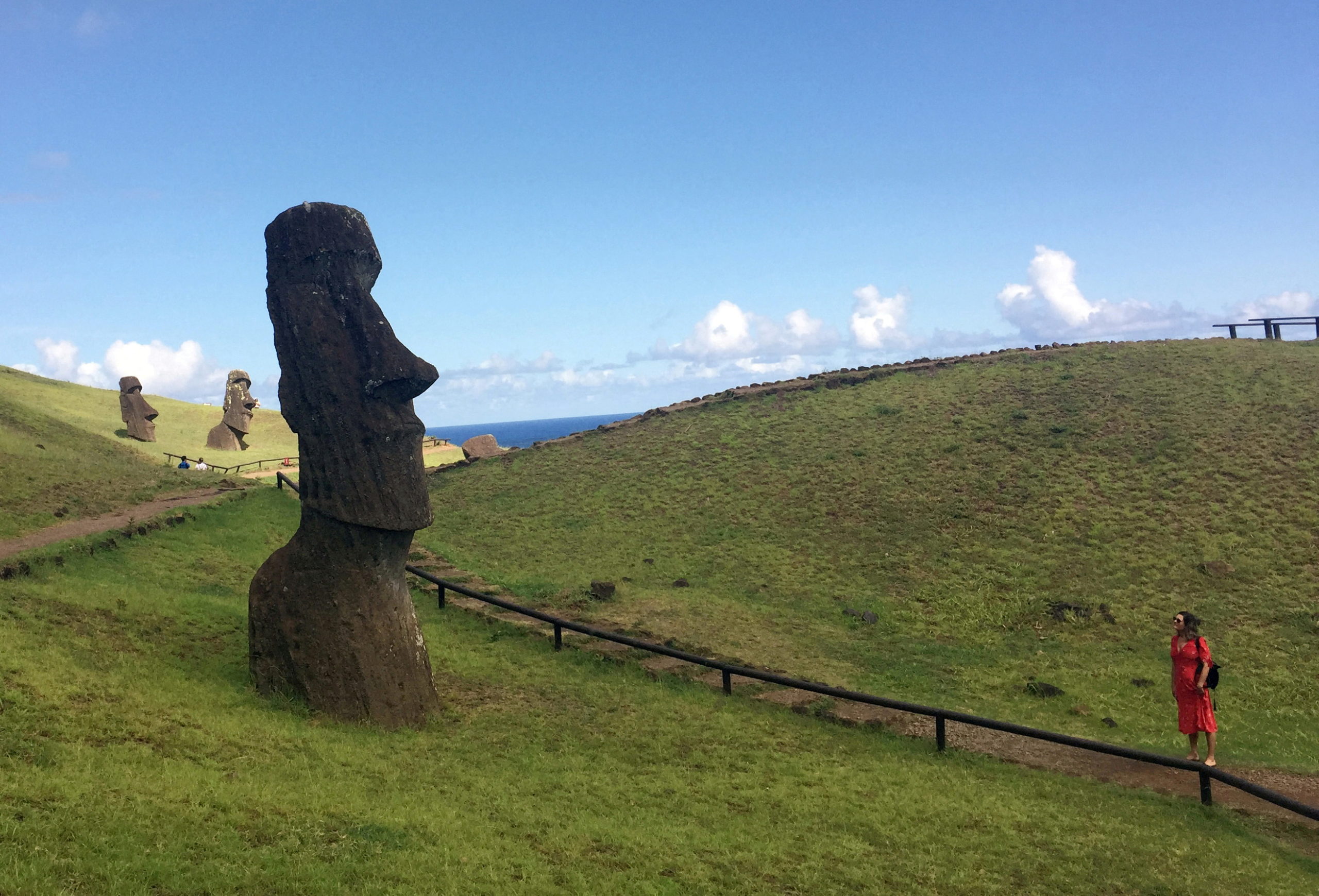FILE PHOTO: A tourist looks at a statue named "Moai" at Easter Island, Chile February 13, 2019. Picture taken February 13, 2019. REUTERS/Marion Giraldo/File Photo