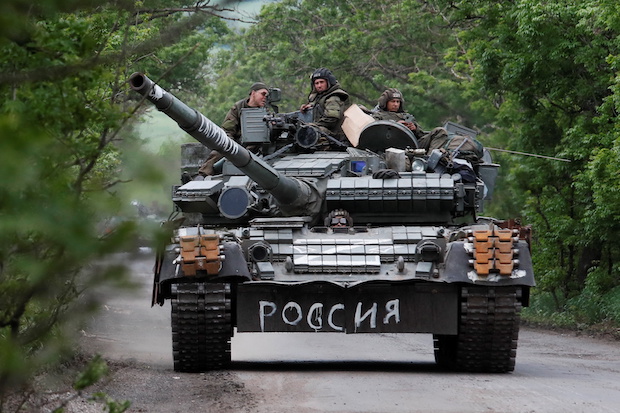 Service members of pro-Russian troops drive a tank in the Donetsk Region. STORY: Russian forces target key towns in eastern Ukraine