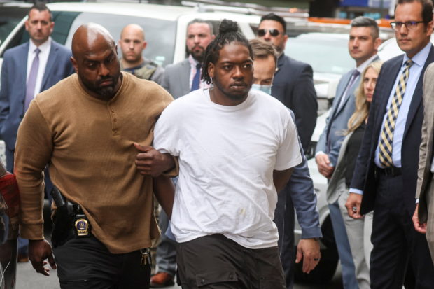 New York Subway shooting suspect Andrew Abdullah is escorted by New York City Police (NYPD) Detectives as he arrives to turn himself in at a Police Precinct in New York City, U.S., May 24, 2022.  REUTERS/Brendan McDermid