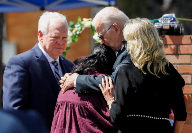 U.S. President Joe Biden embraces Mandy Gutierrez, Principal at Robb Elementary School, where a gunman killed 19 children and two teachers in the deadliest U.S. school shooting in nearly a decade,  as first lady Jill Biden and Uvalde Consolidated Independent School District (C.I.S.D.) Superintendent Hal Harrell stand next to him, in Uvalde, Texas, U.S. May 29, 2022. REUTERS/Marco Bello