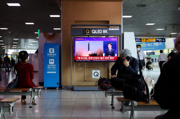 FILE PHOTO: People watch a TV broadcasting a news report on North Korea's launch of three missiles including one thought to be an intercontinental ballistic missile (ICBM), in Seoul, South Korea, May 25, 2022.     REUTERS/Kim Hong-Ji/File Photo