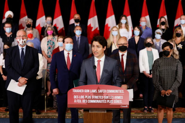 Canada's Prime Minister Justin Trudeau, with government officials and gun-control advocates, speaks at a news conference about firearm-control legislation that was tabled today in the House of Commons in Ottawa, Ontario, Canada May 30, 2022. REUTERS/Blair Gable
