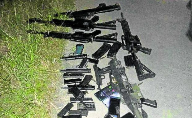 FIREPOWER Police in Nueva Ecija have laid out for inventory the high-powered firearms seized from supporters of rival political camps in General Tinio town who figured in a gunfight on Saturday night. —CONTRIBUTED PHOTO