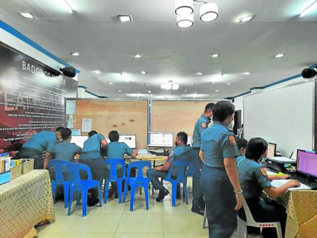 ON WATCH A team of policemen monitors election-related reports in Central Visayas region at the Regional Election Monitoring Action Center in Cebu City to ensure the peaceful and orderly conduct of elections on Monday. STORY: Election eve killings in Central Visayas probed
