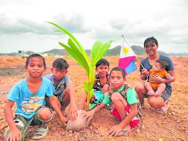 Sagip Coron Palawan leads a tree-planting activity during the celebration of Earth Day last month hoping to turn into green the barren reclaimed area in the town. STORY: STORY: Saving Coron: Group rejoices over halt in reclamation project