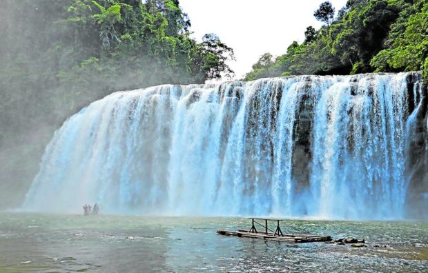 Tourists take a bamboo raft to experience the large curtain-like water shower of Tinuy-an Falls in Bislig City, Surigao del Sur. STORY: Bislig City braces for rising number of tourist visits