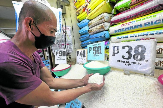 Eddie Pascual waits for customers at a rice stall in Marikina City public market in this photo on May 13. Attaining food security and bringing down the price of the staple, selling between P38 and P90 a kilo in Pascual’s stall, have become major campaign issues in this year’s elections. STORY: Goal of P20 per kilogram rice needs full gov’t support – solon