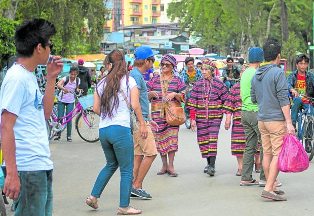 Ibaloy women walking on the street in Baguio. STORY: Baguio's gains, losses in modern charter