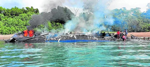 WRECKAGE MV Mercraft 2 is towed to Baluti Island in Real, Quezon, several hours after it was engulfed by fire on Monday morning. —PHOTO COURTESY OF PHILIPPINE COAST GUARD