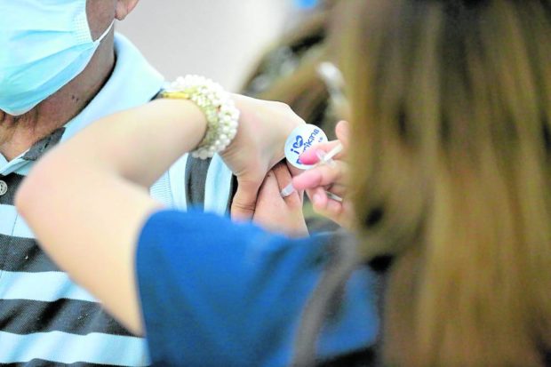 Marikina resident gets vaccinated against COVID-19. STORY: COVID-19 admissions in hospitals inch up