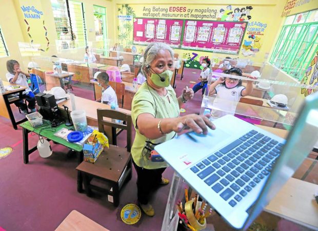 A Grade 1 teacher at Epifanio delos Santos Elementary School in Manila holds physical classes with a limited number of pupils. STORY: Students back to campuses by August – DepEd