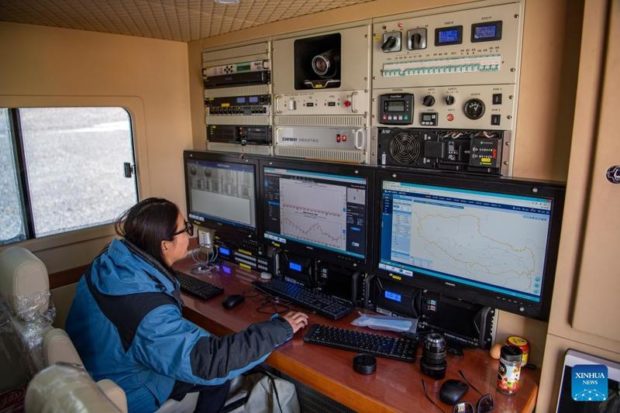 A staff member of the Meteorological Bureau of Tibet Autonomous Region checks real-time data in an emergency support vehicle at the Mount Qomolangma base camp on May 3, 2022