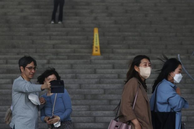 South Korea drops outdoor mask rule but many prefer to keep them on