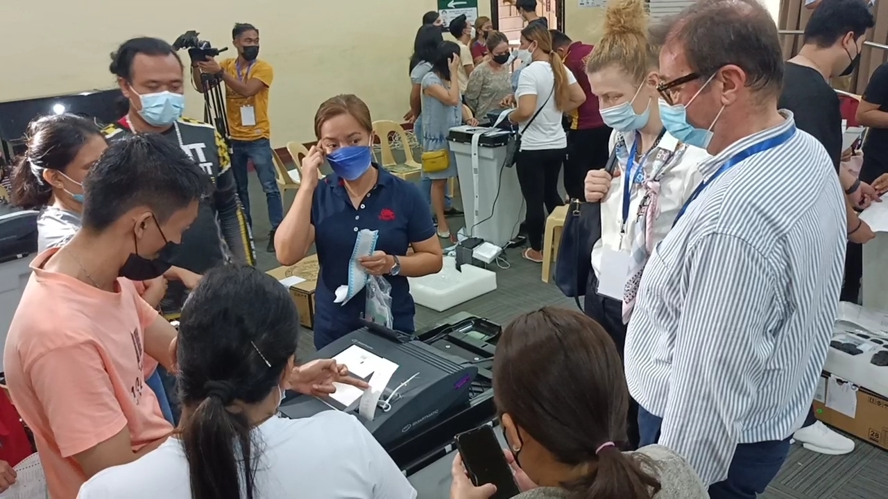 Officials of the Commission on Elections (Comelec) lead the final testing and sealing of the vote counting machines